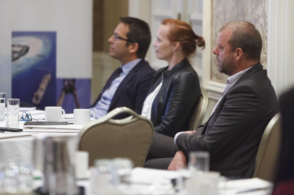 audience members listen intently to the presentation