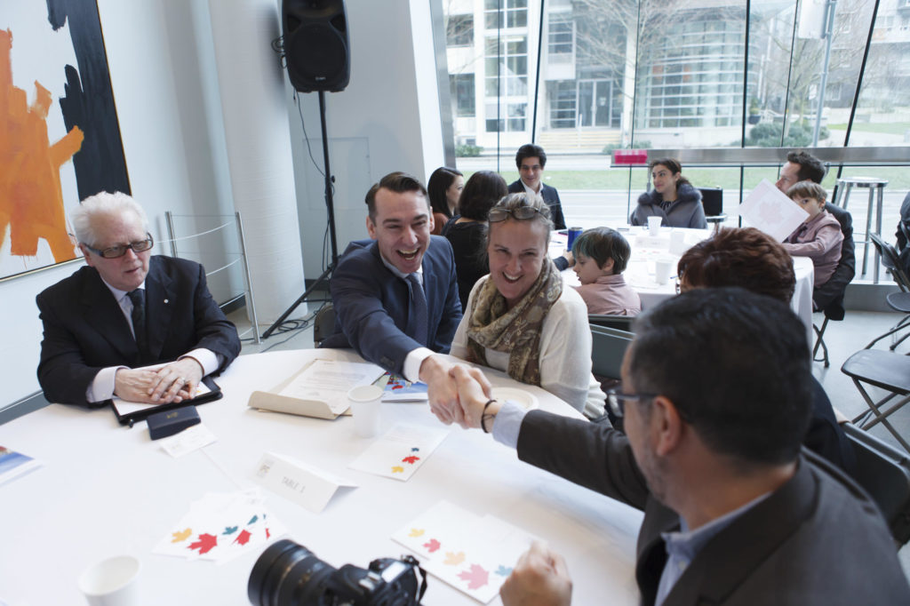 shaking hands at roundtable discussion