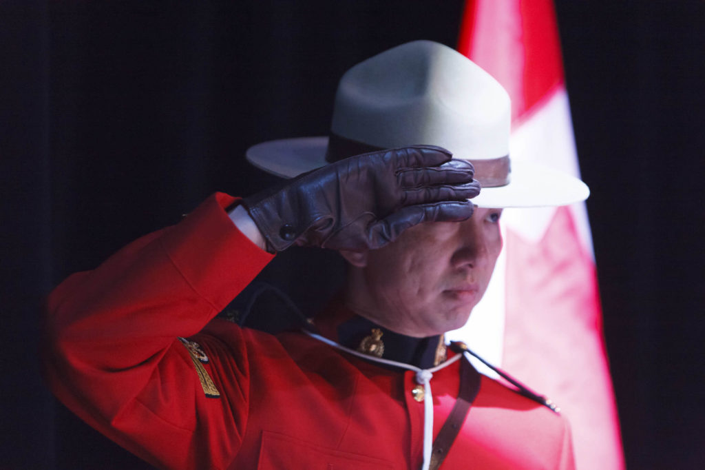 a mountie salutes during oath of citizenship