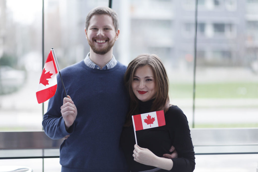 couple holding the canadian flag
