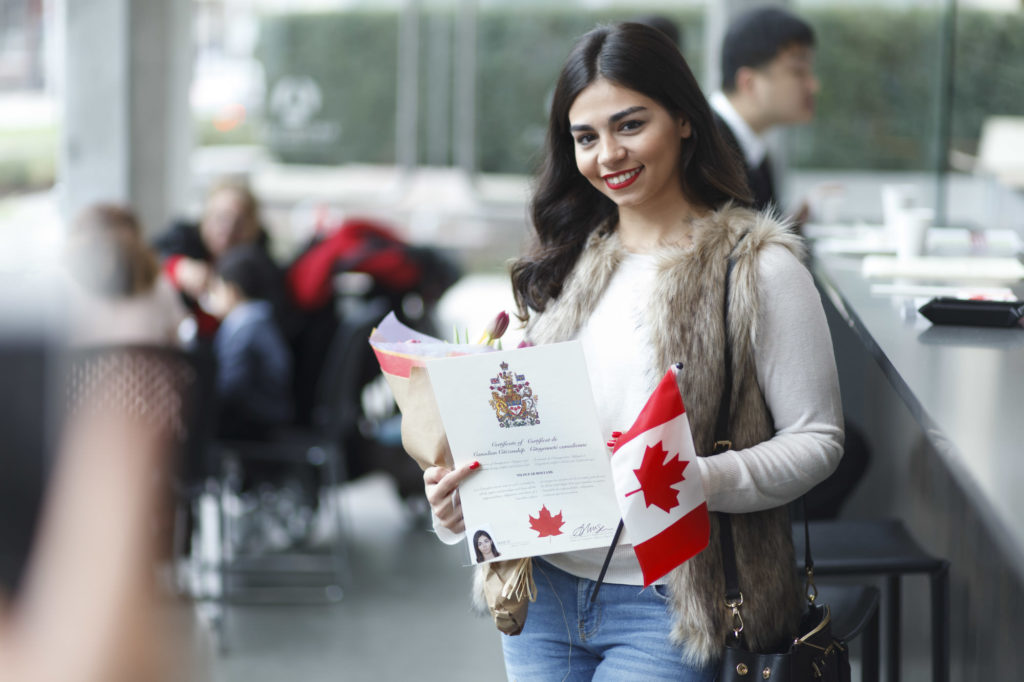 posing for photos with citizenship certificate