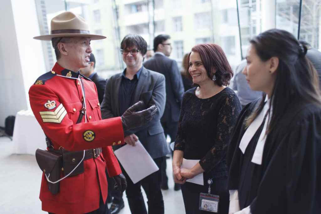 participants speak with a mountie after the event