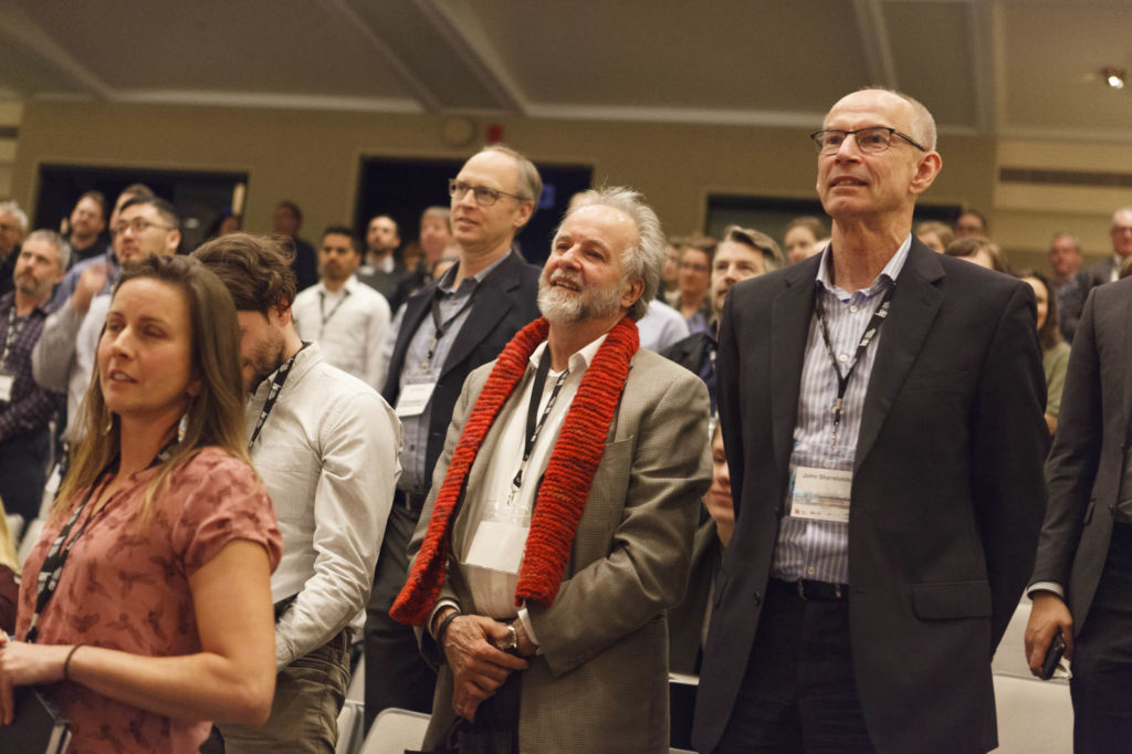 audience members smile during a presentation
