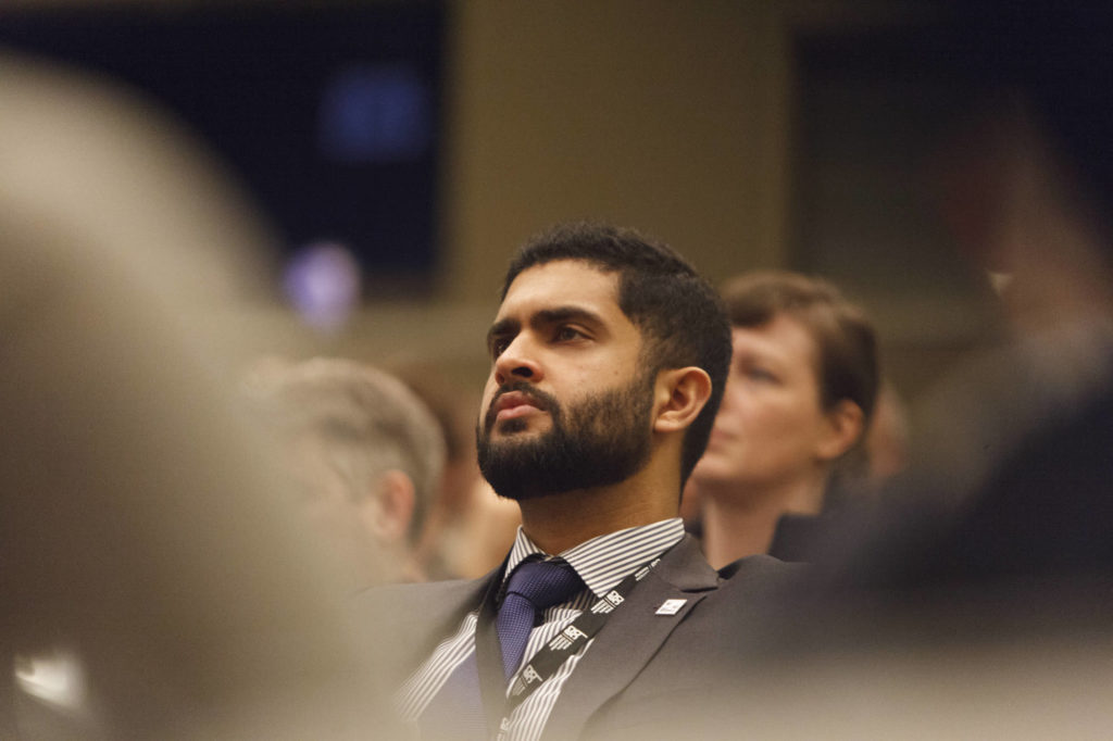 audience member listens to the speaker
