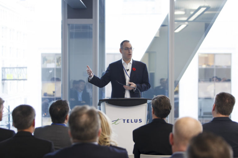 A man makes a presentation to an audience during a conference at the Telus building in Vancouver