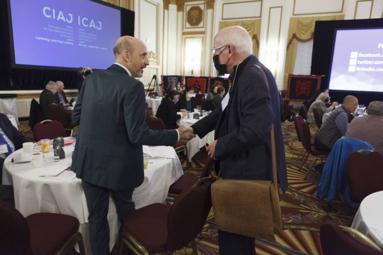 shaking hands and networking at the CIAJ conference