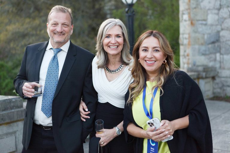 Three event attendees smile for the camera during a retreat at Hatley Caste in Victoria