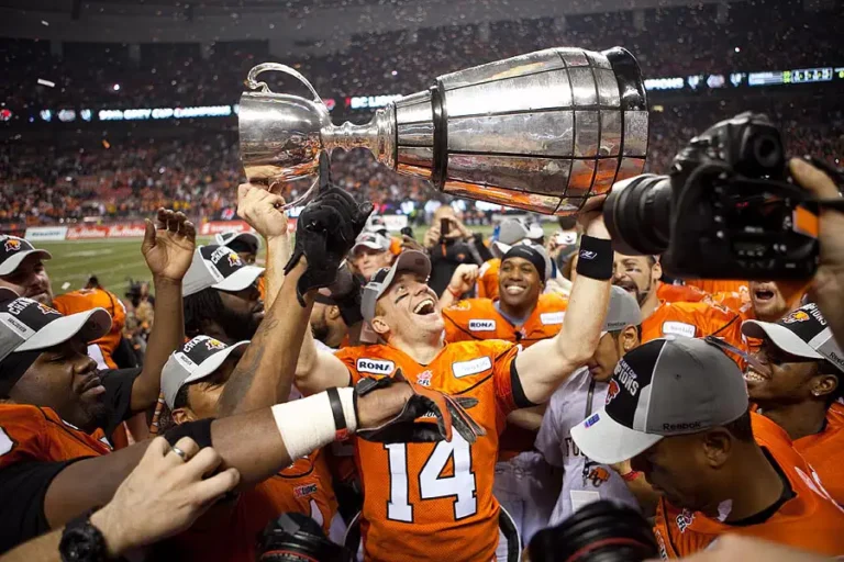BC Lions quarterback hoisting the Grey Cup in celebration of their win at the 99th Grey Cup – Victoria event photography coverage