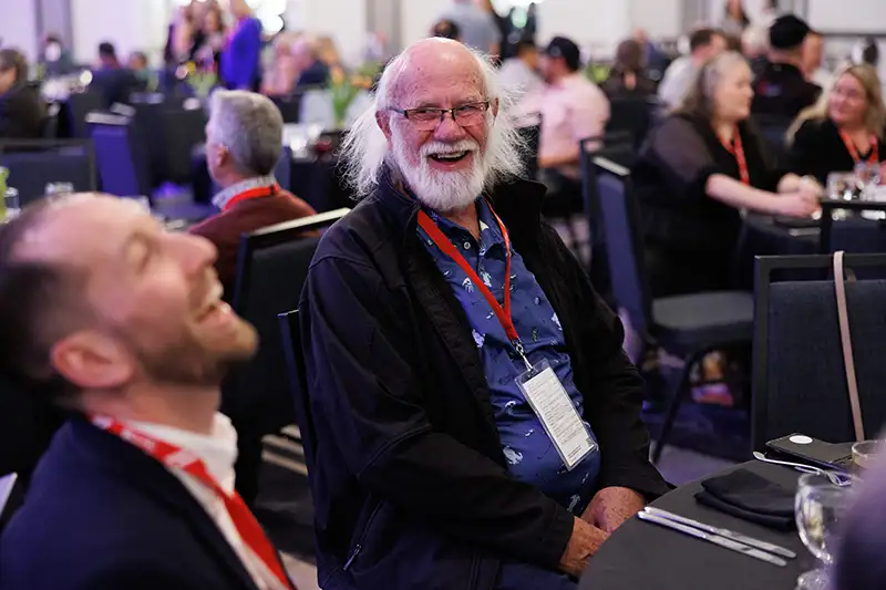 participants at an awards ceremony laugh together
