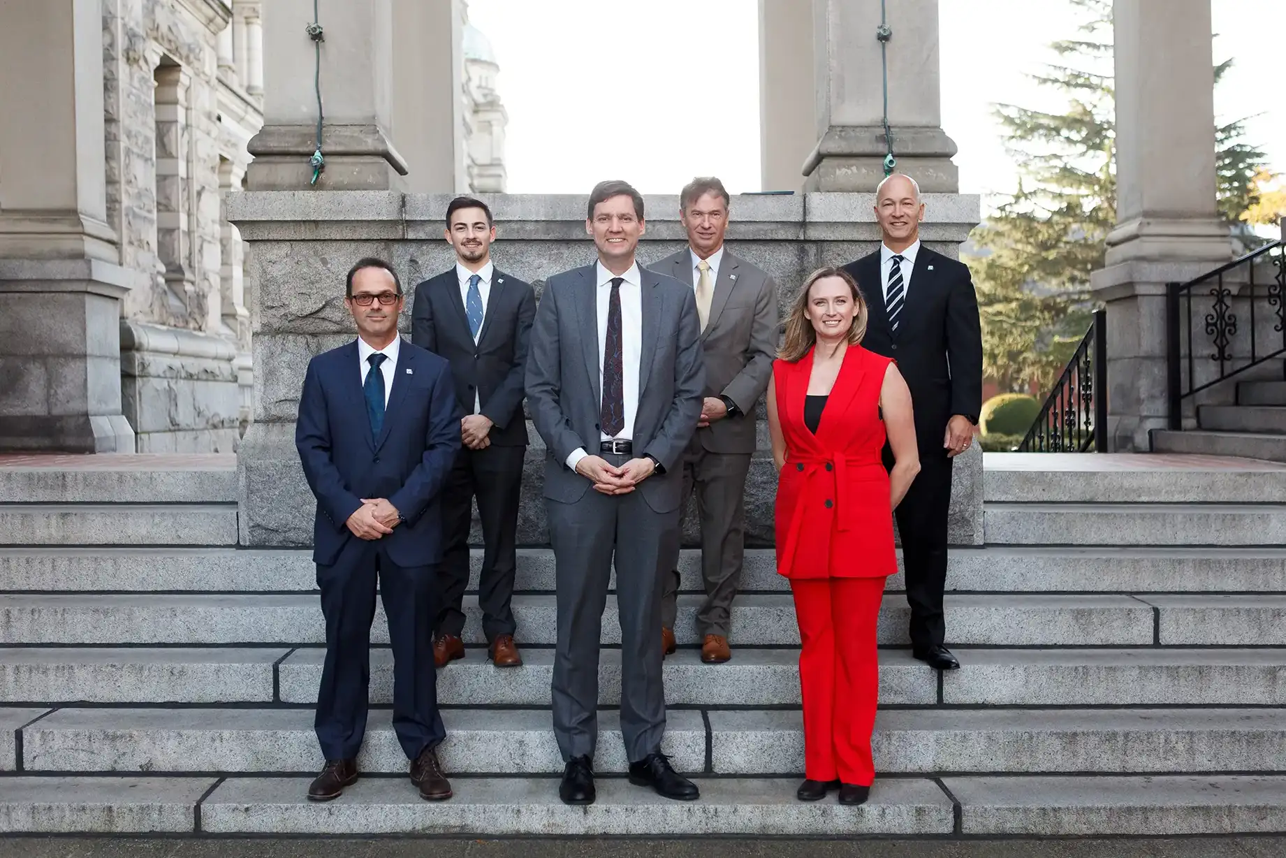 Members of a non-profit advocacy group pose for a group photo with Premier David Eby at the B.C. Legislature