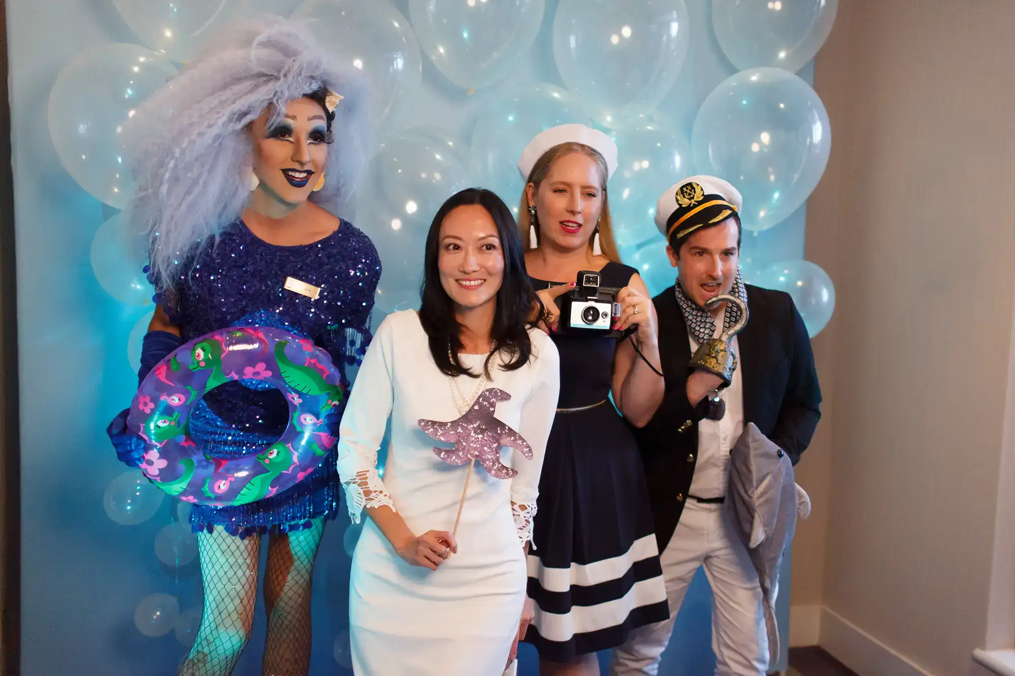 a group of people pose at a Photo Booth during a celebration night