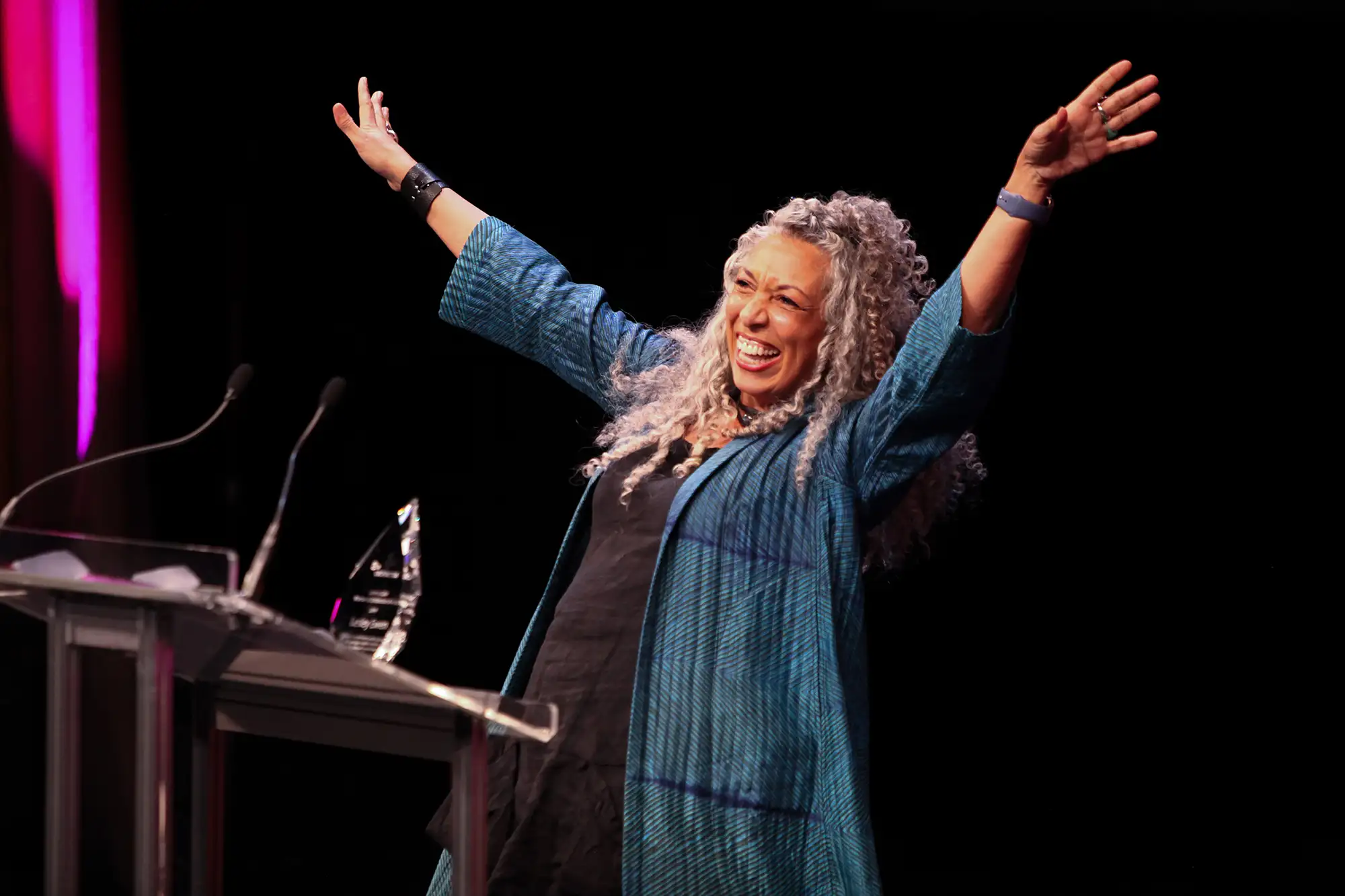 Awards photography in Vancouver of a UBCP award winner with their hands in the air ,celebrating their win
