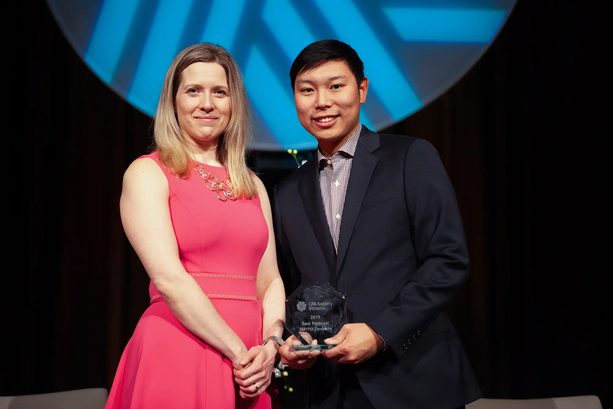 a man accepts an award from a presenter at the CFA forecast event in Victoria BC