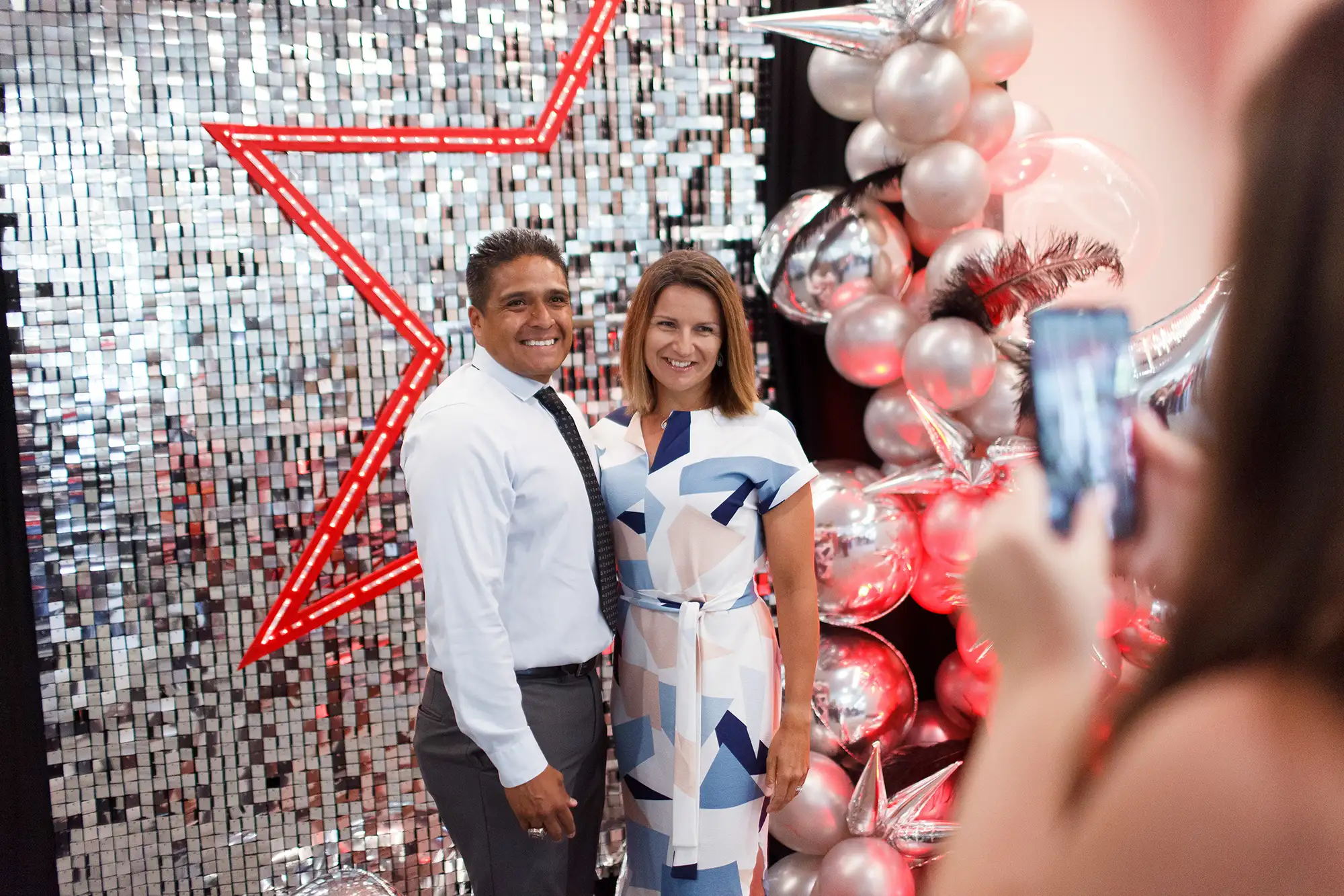 a couple poses in a photo booth during an awards night in Victoria BC