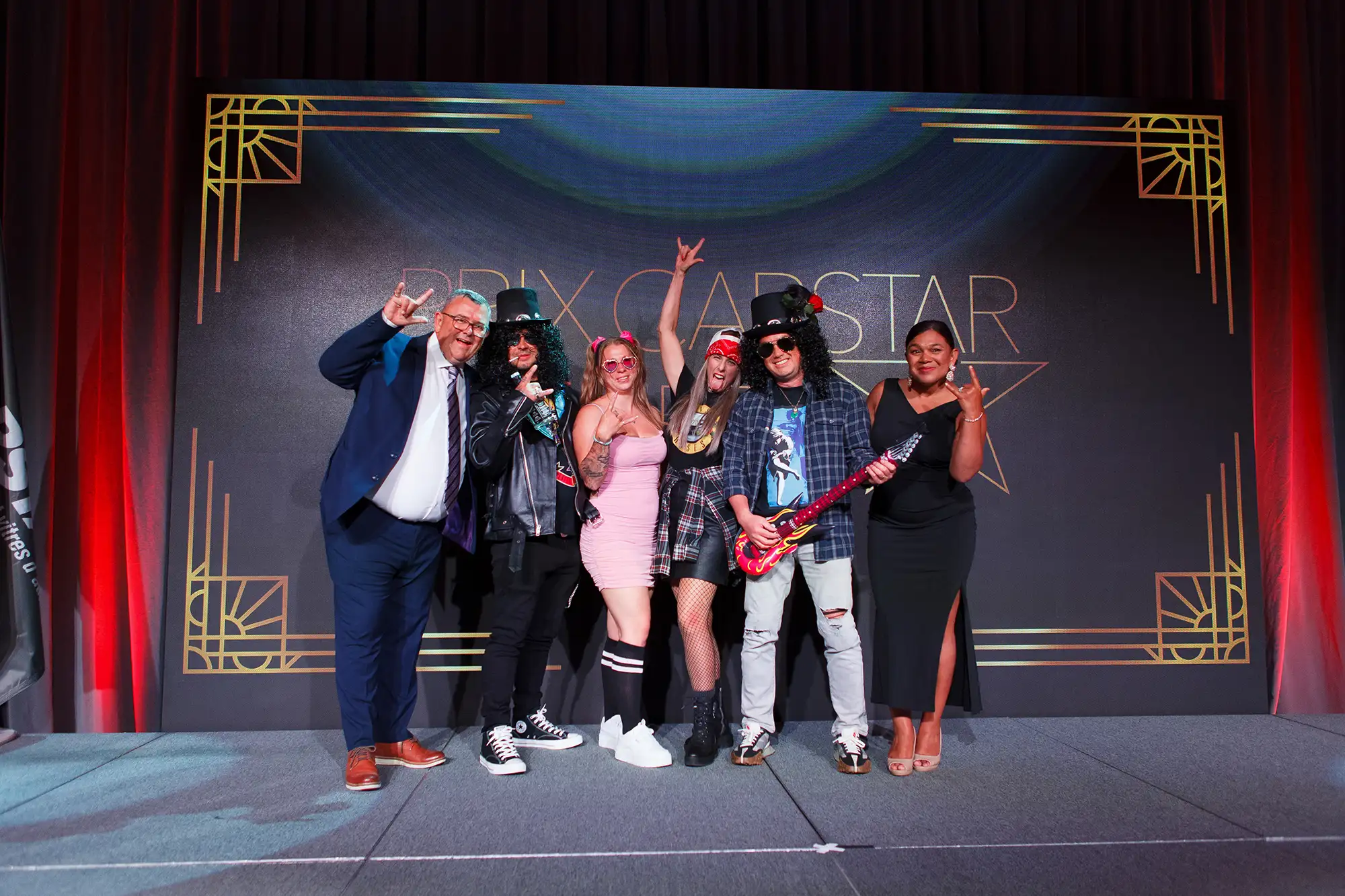 a group wins best costume award onstage at a Carstar event in Victoria BC