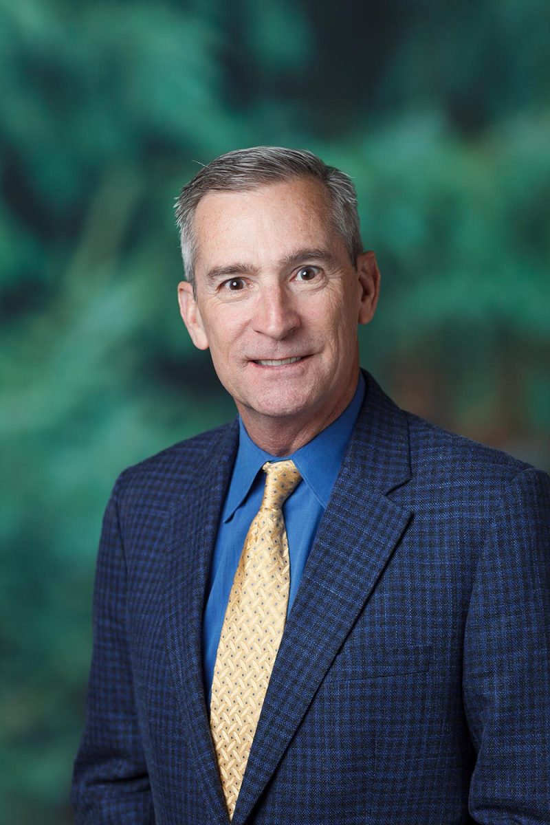 Executive headshots in Victoria BC during the ASIC conference, posing by a green backdrop