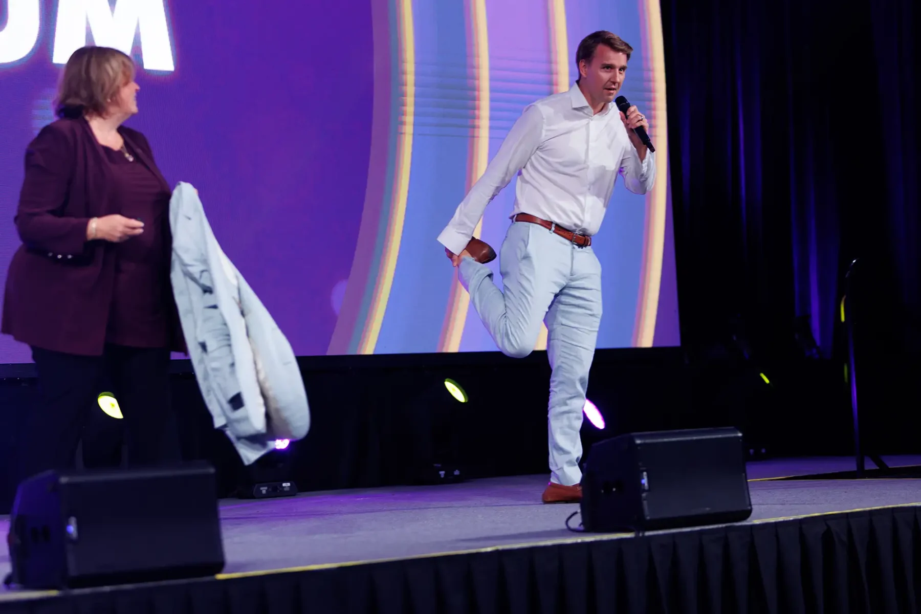 A presenter at the CSAE Momentum conference jokes around on stage in Victoria BC