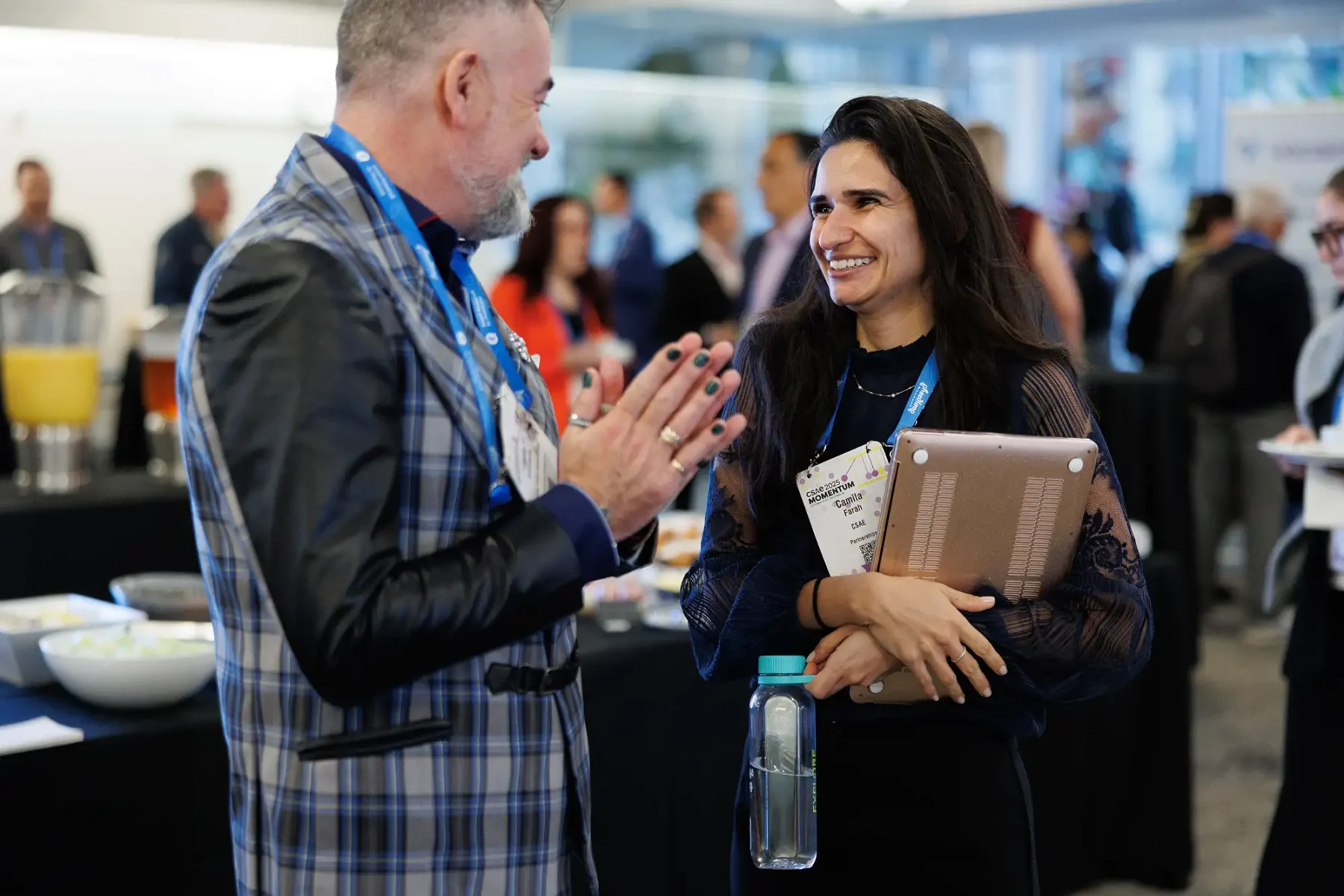 Conference attendees smile during a networking event at CSAE Momentum 2025