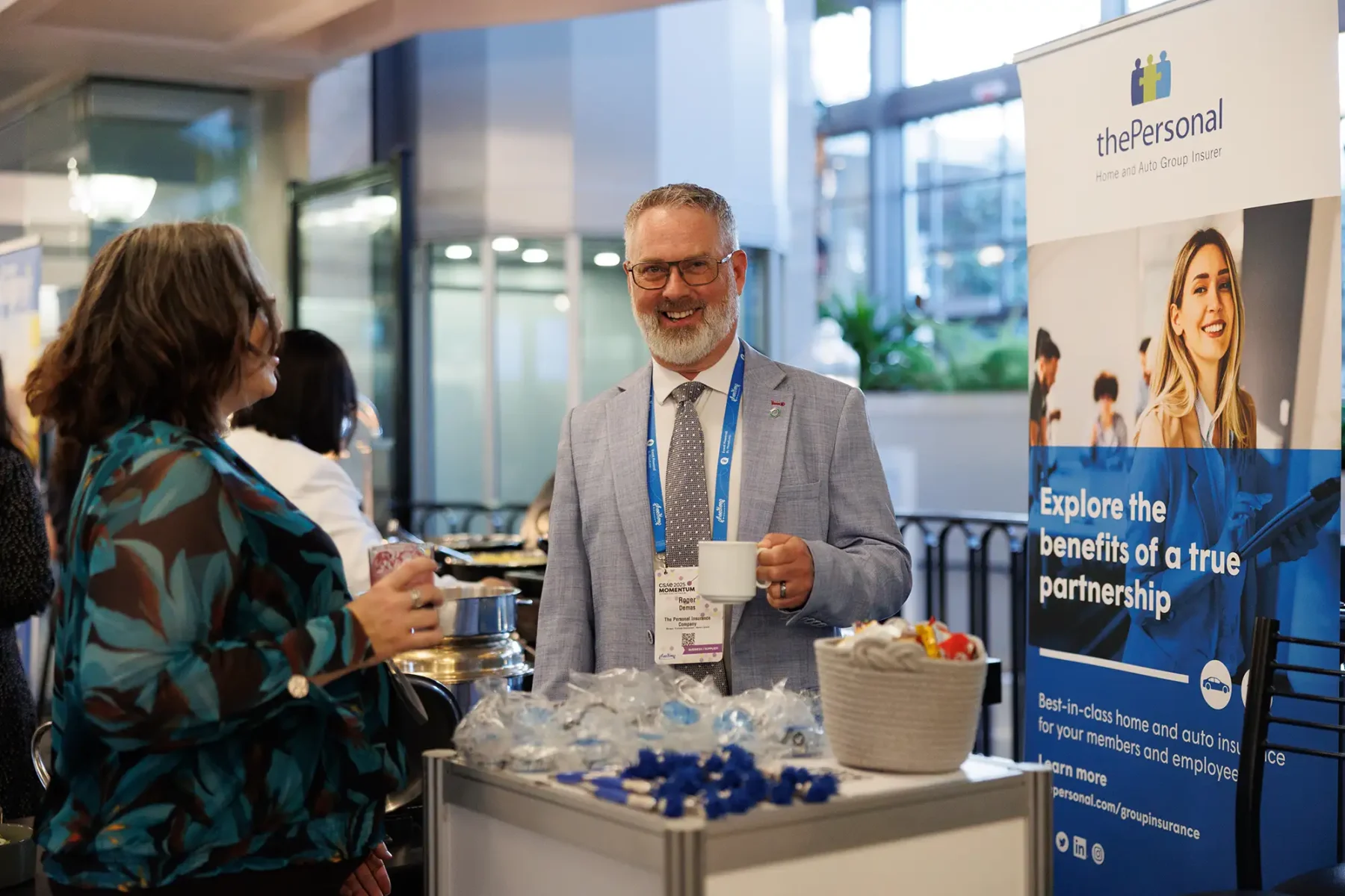 a vendor smiles during tradeshow activity at the Victoria Conference Centre