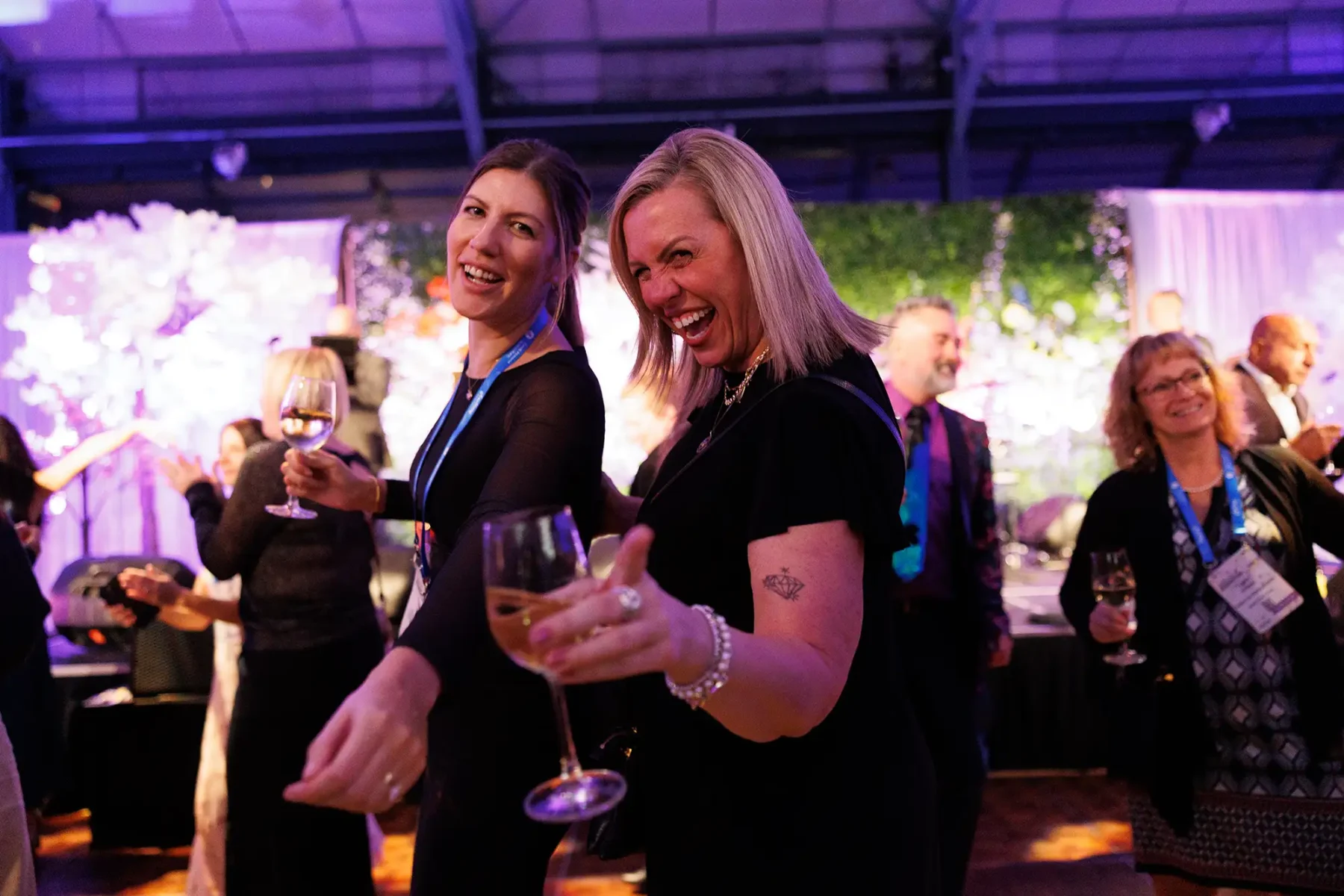 two women dance during conference photography at Crystal Gardens in Victoria BC