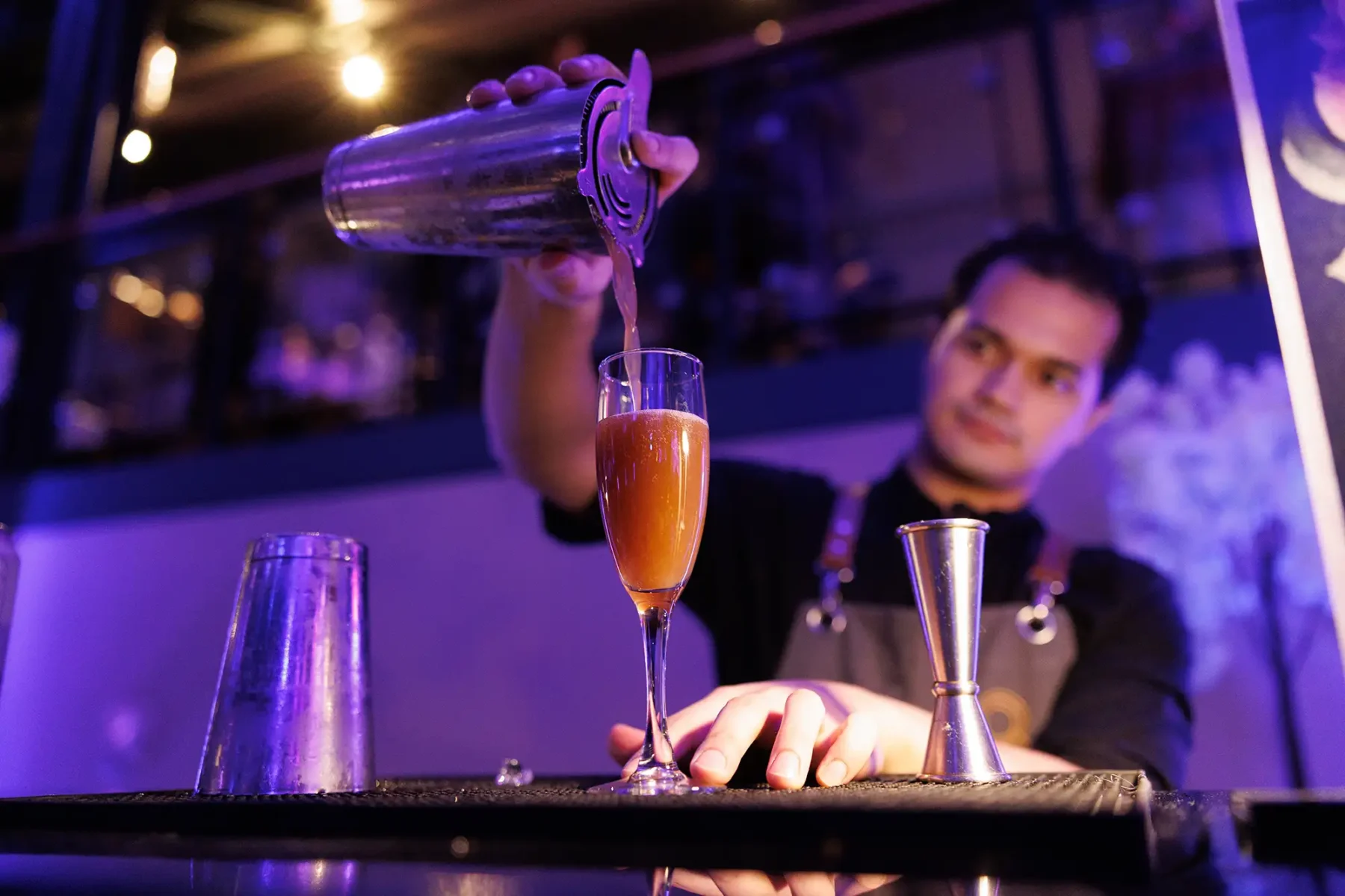 a bartender pours a drink during a reception at the CSAE conference in Victoria BC