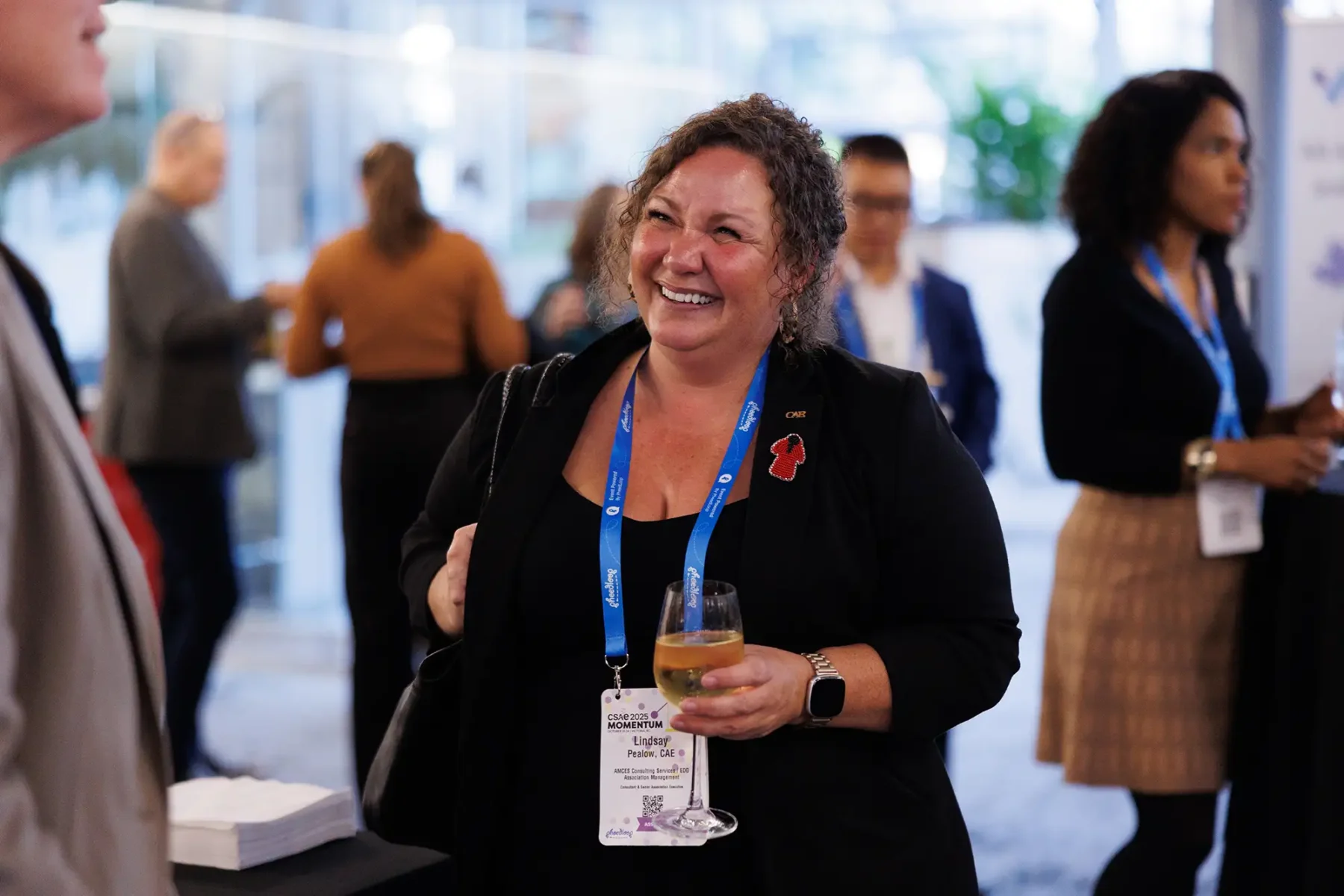 A conference attendee smiles during networking break at the Victoria Conference Centre