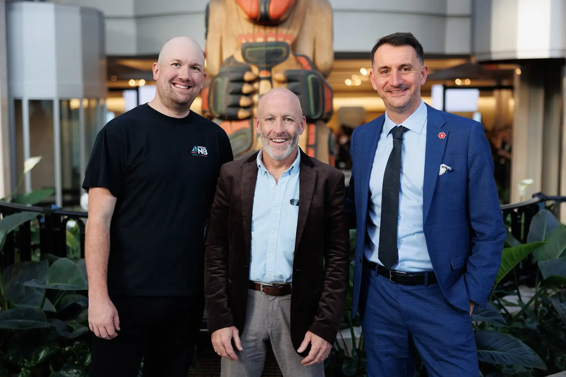 Three men pose for a photo during the CSAE conference in Victoria BC