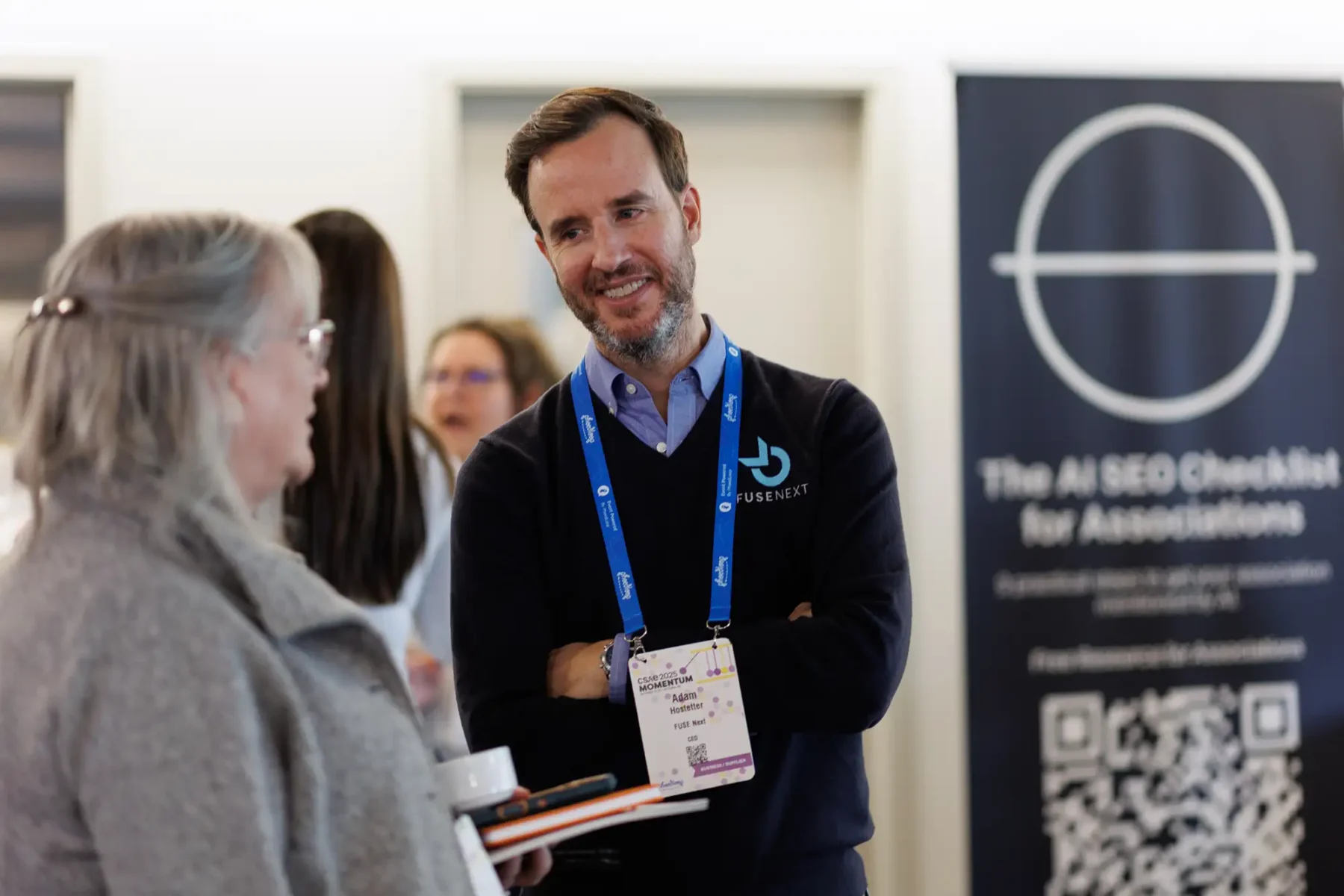 A conference vendor smiles during networking at the Victoria C0nference Centre