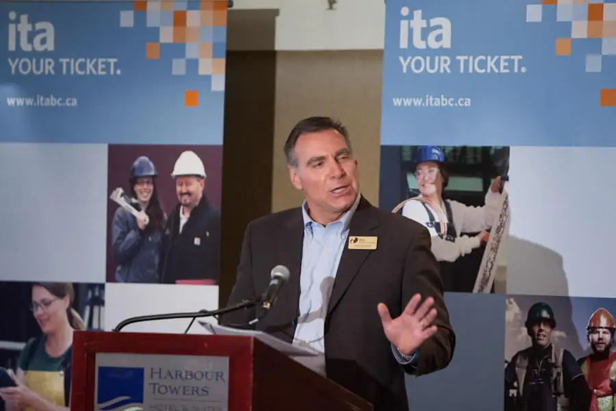 Executive speaks at a podium during an industry funding press conference, event photographer coverage in Victoria