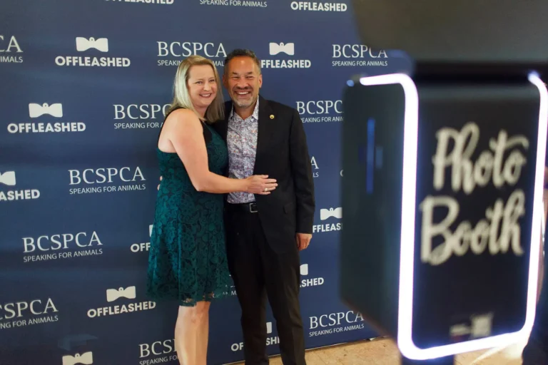 a couple pose at a photobooth during an SPCA non-profit fundraiser