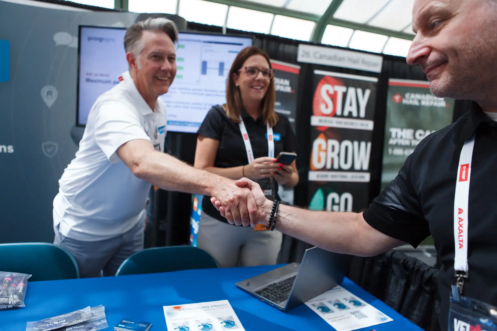 a trade show vendor and conference attendee shake hands at the Victoria crystal gardens