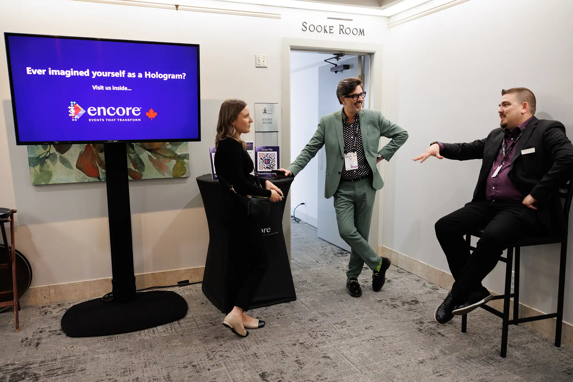 trade show participants and vendors chat outside of an encore brand activation setup room