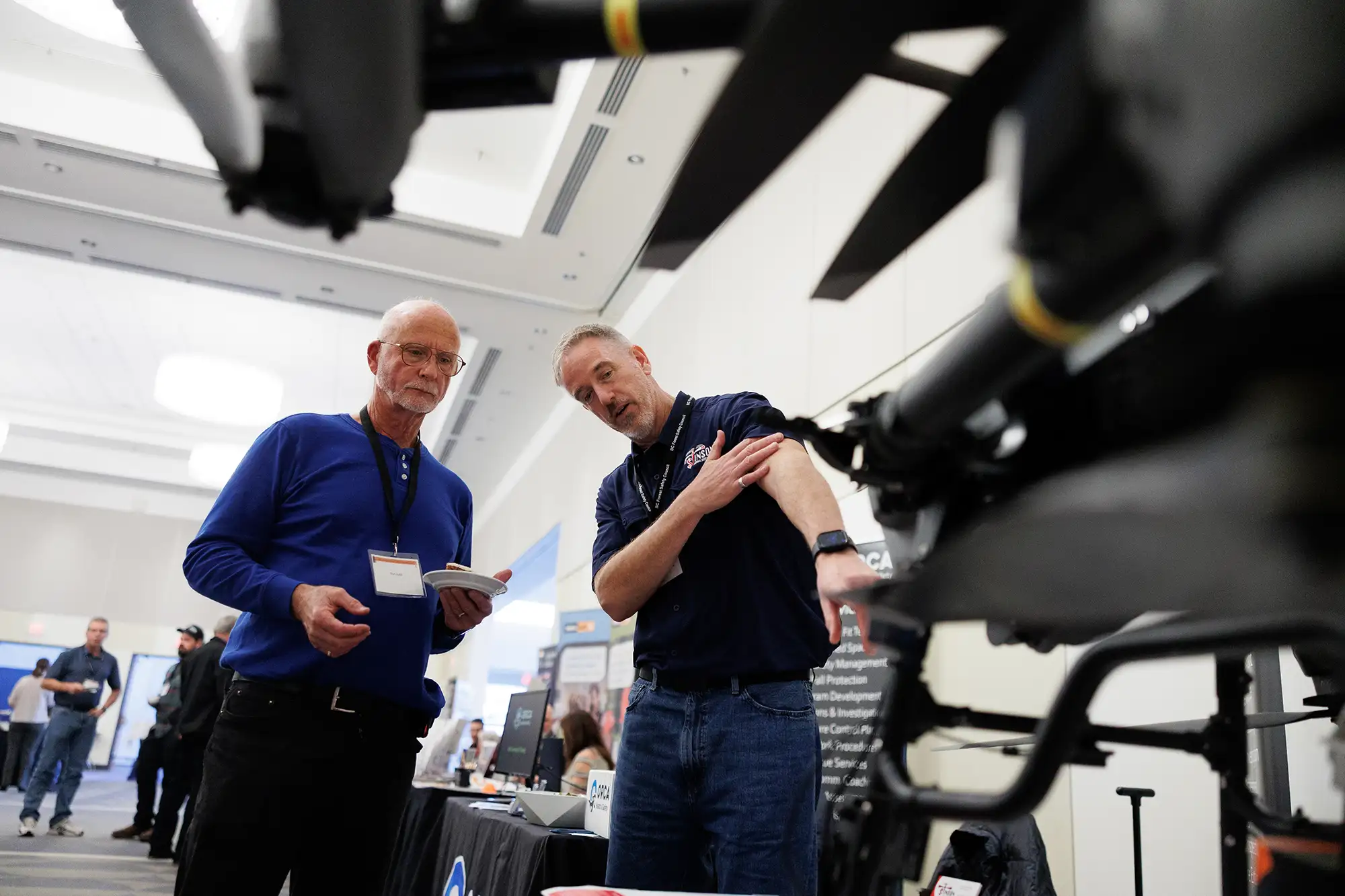 two men look at a large drone during the Vancouver Island forest safety conference exhibition
