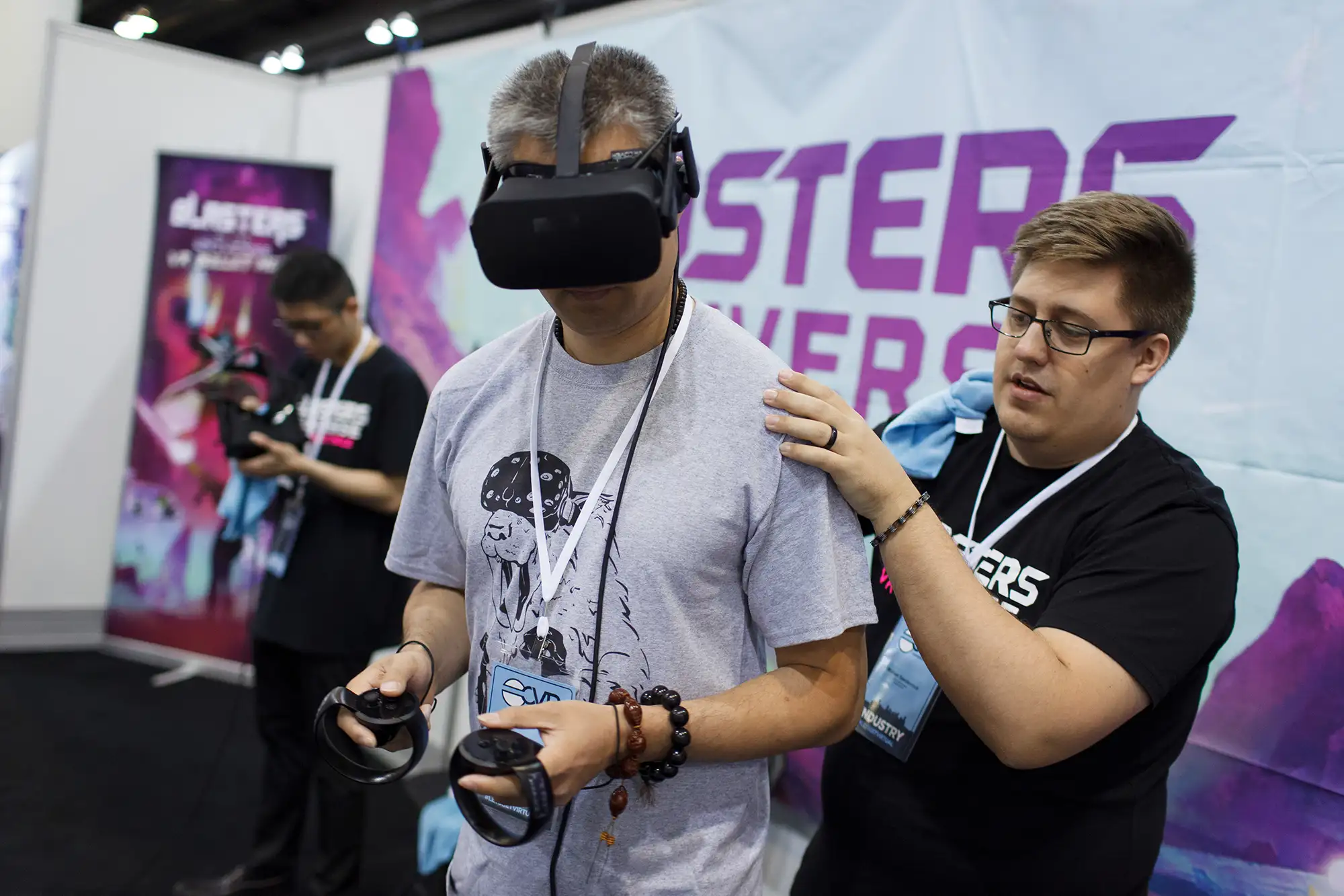 an industry exhibition vendor guides an Archiact VR conference attendee through a session