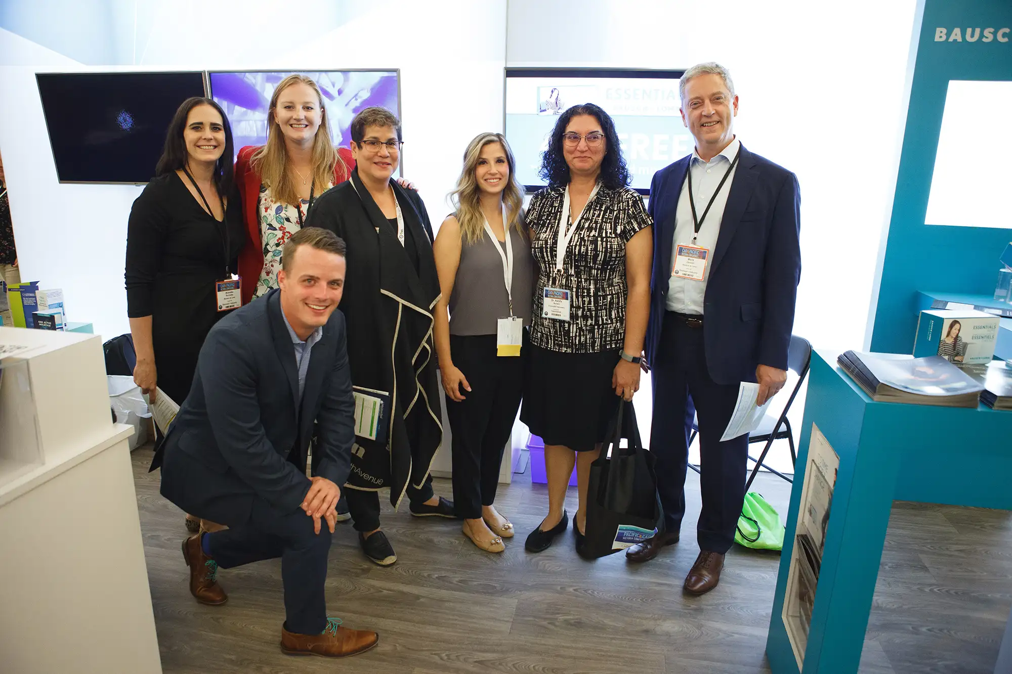 group portrait of a sponsor booth at a Victoria conference