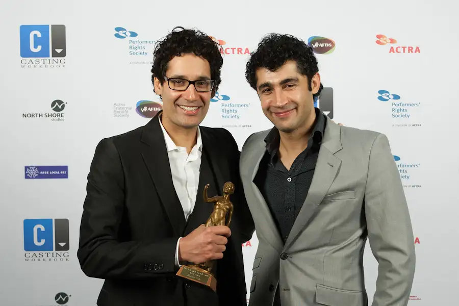 Award winners posing with their trophy at the UBCP Awards step-and-repeat in Vancouver, captured by Victoria awards photographer Geoff Howe.