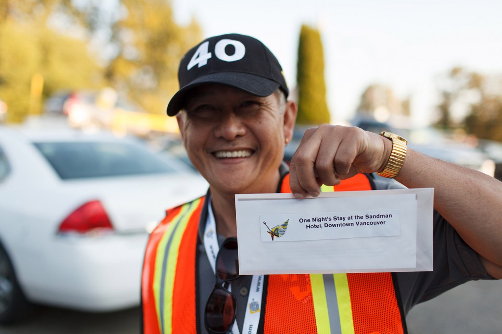 a man holds up a gift certificate at the kryton party