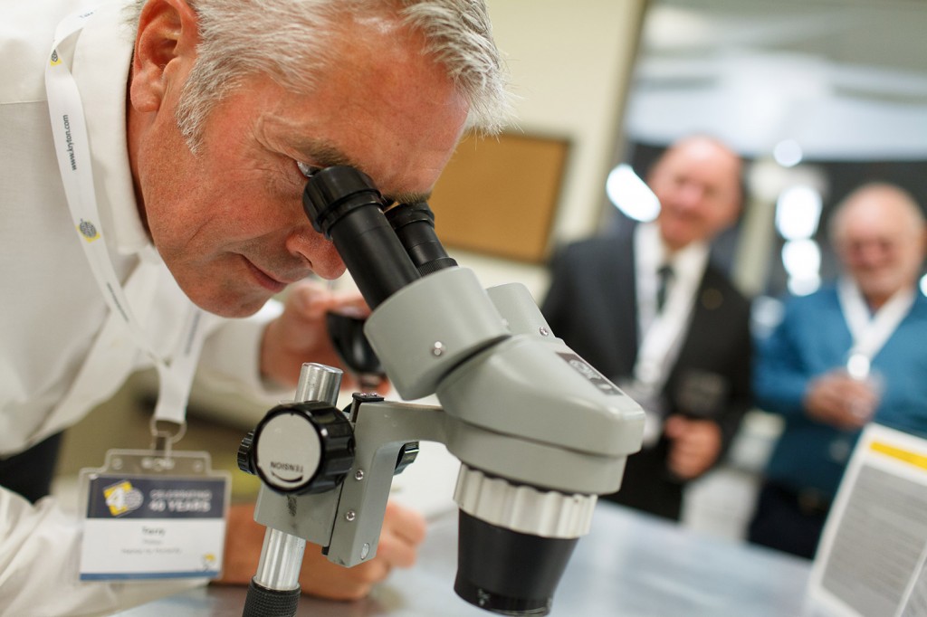 a man looks through a microscope at kryton