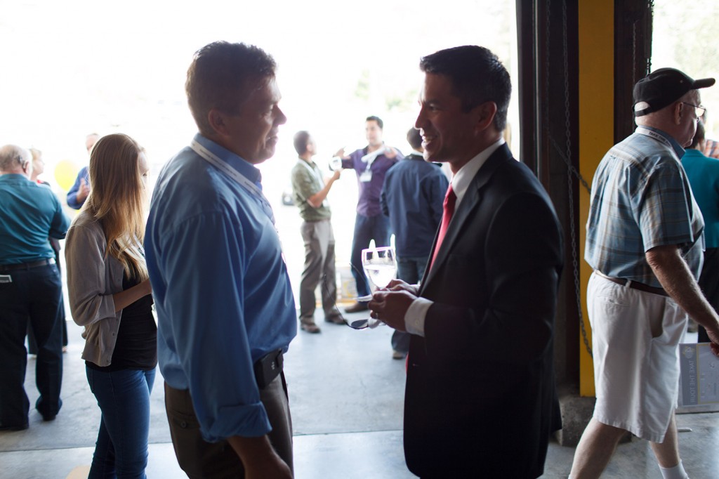 photos of people speaking together at anniversary