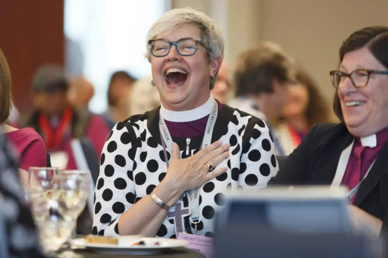 Anglican General Synod session participant laughing at the Sheraton Vancouver Wall Centre – example of Victoria event photography